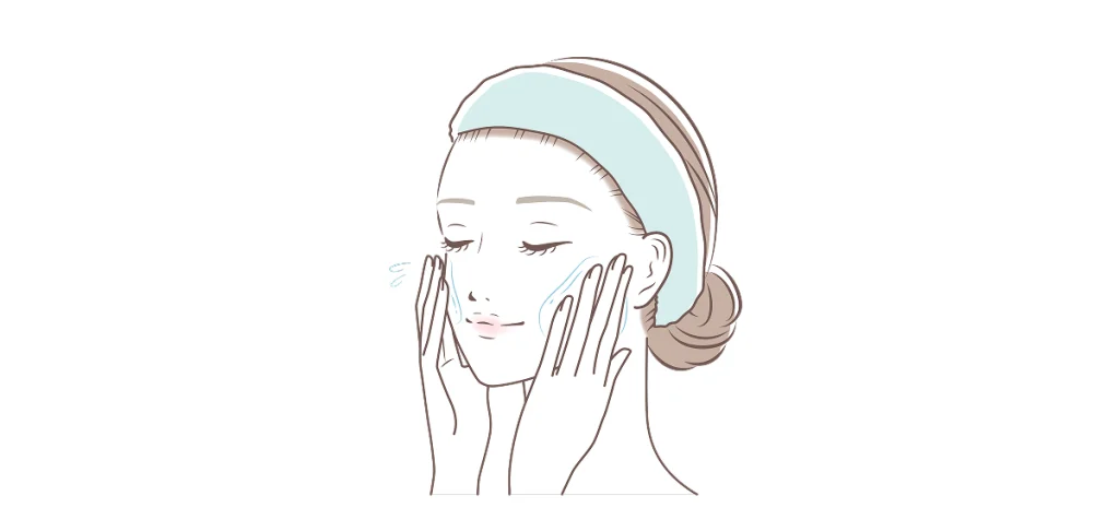 両ほほに手を当てている女性